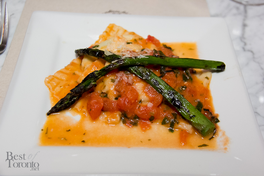 Raviolini stuffed with ricotta and spinach, fresh tomato  and basil sauce, topped with sauteed asparagus