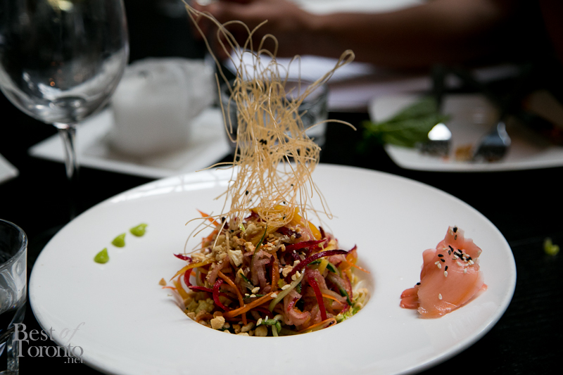 Crunchy asian salad with napa cabbage, vegetable whispers, toasted peanuts and drizzled with Asian sauce