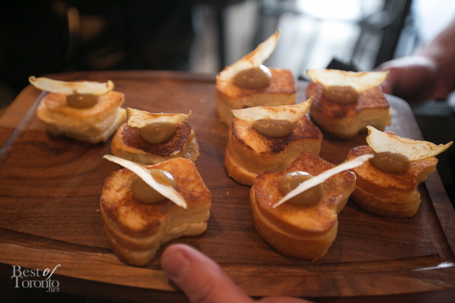 Grilled cheese bites topped with apple butter and a chip for appetizers