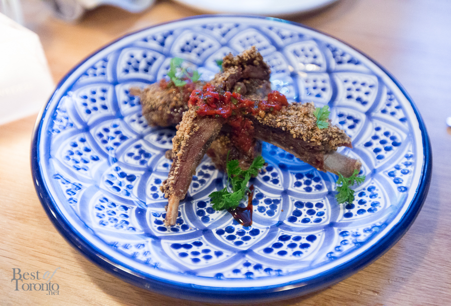 Lamb Ribs Dukkah with buttermilk sauce, carob molasses, and red chili schug
