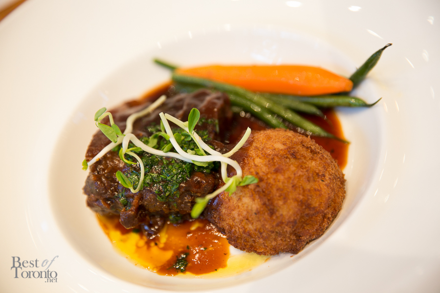 Braised beef short ribs served with horseradish potato croquette and seasonal vegetables