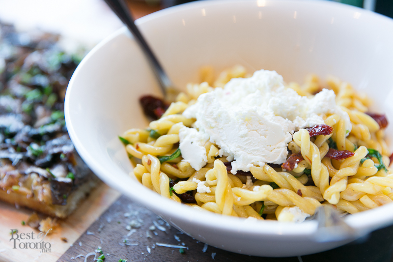 Trecce pasta with garlic infused olive oil, chili flake, sundried tomato, goat's cheese, arugula