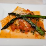 Raviolini stuffed with ricotta and spinach, fresh tomato and basil sauce, topped with sauteed asparagus