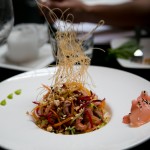 Crunchy asian salad with napa cabbage, vegetable whispers, toasted peanuts and drizzled with Asian sauce