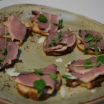 Smoked duck ham with caramelized red onion and goat Gouda