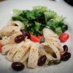 Grilled calamari with caramelized onions, kalamata olives, capers, local grape tomatoes, roasted garlic