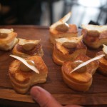 Grilled cheese bites topped with apple butter and a chip for appetizers