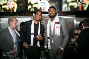 DeMar DeRozan, Amir Johnson of the Toronto Raptors serving drinks at Real Sports Bar
