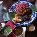 "Cochinita Pibil" with Southern style pork butt in ahciote and orange juice marinade, roasted in banana leaves, pulled and served with fried plantains, pickled red onions and salsa Pancho (habaneros, tomatillo, serrano salsa)