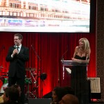 Auctioneer, Jay Mandarino on stage with Carla Collins