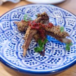 Lamb Ribs Dukkah with buttermilk sauce, carob molasses, and red chili schug