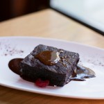"Mexican Chocolate Fudge Brownie" with guajillo chili and salted caramel sauce. Vegan-friendly.