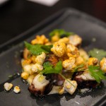 Octopus served as a snack with popcorn, lime, cilantro