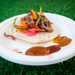 Smoked duck tacos with pickled radish, carrots, crispy fried chicken skin, and a hoisin BBQ sauce on a flour tortilla from Barque Smokehouse