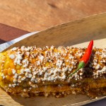 A fully dressed Mexican Elote corn on the cob by CORNehCopia