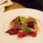house-cured, air-dried Bison “Pemmican” Bresaola is thinly shaved and paired with house-made lardo, lightly dressed with Chef’s wild blueberry juniper vinaigrette