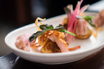 Honey and potato rye ebelskiver, spruce cured trout, crème fraiche, potato petals