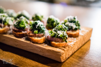 Cotechino and rapini on crostini