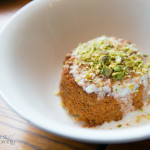 Warm Brown Butter and Coconut Semolina Cake with coconut icing, toasted pistachio